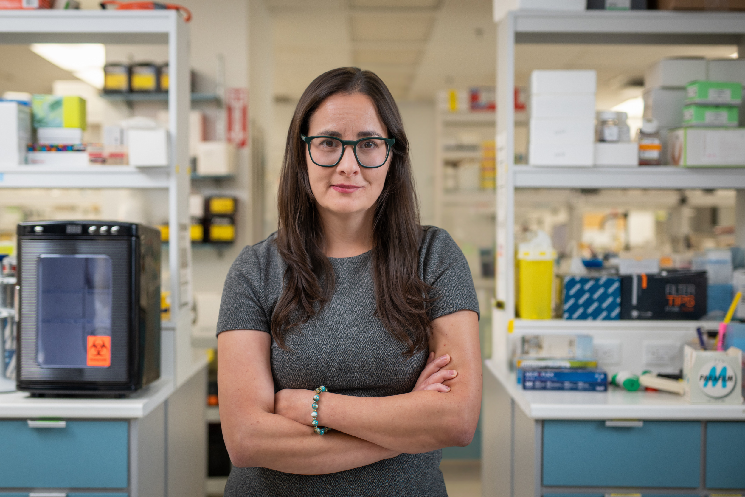 Researcher Jeannette Boudreau standing with crossed arms in her research lab